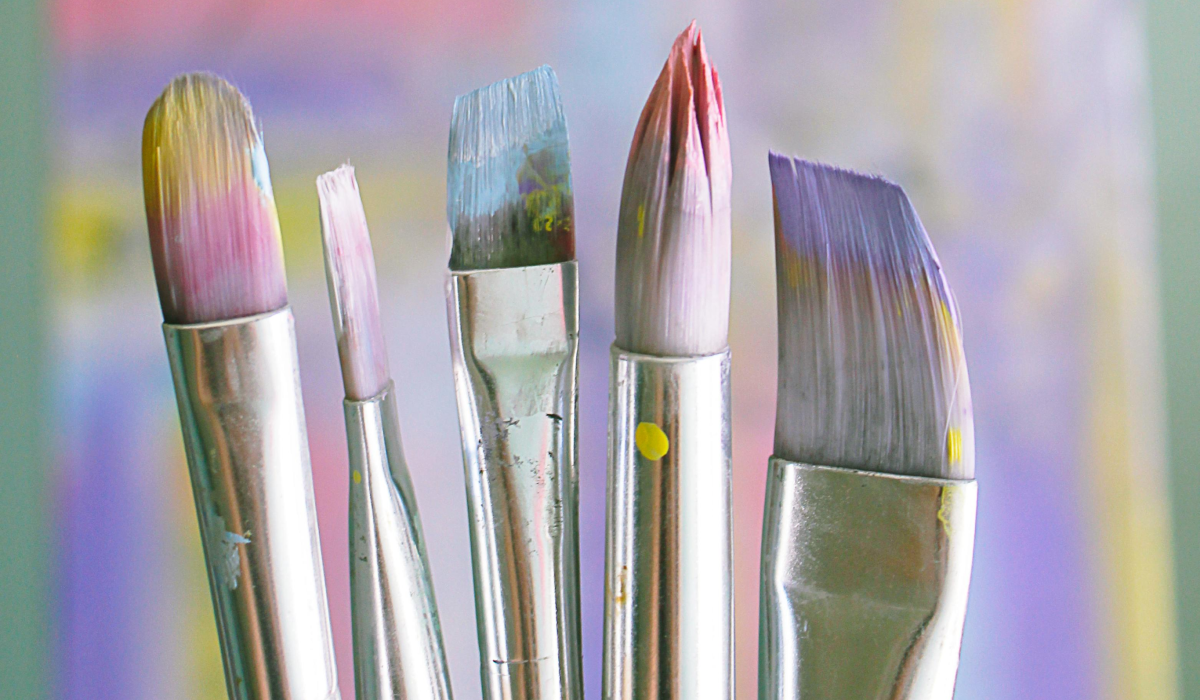 paintbrushes with purple blue paint